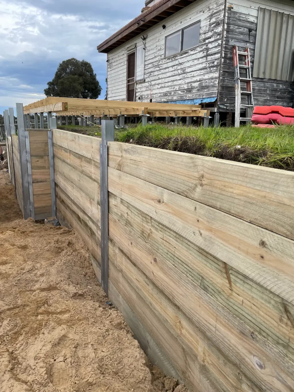 Steel footing foundations supporting a modern retaining wall