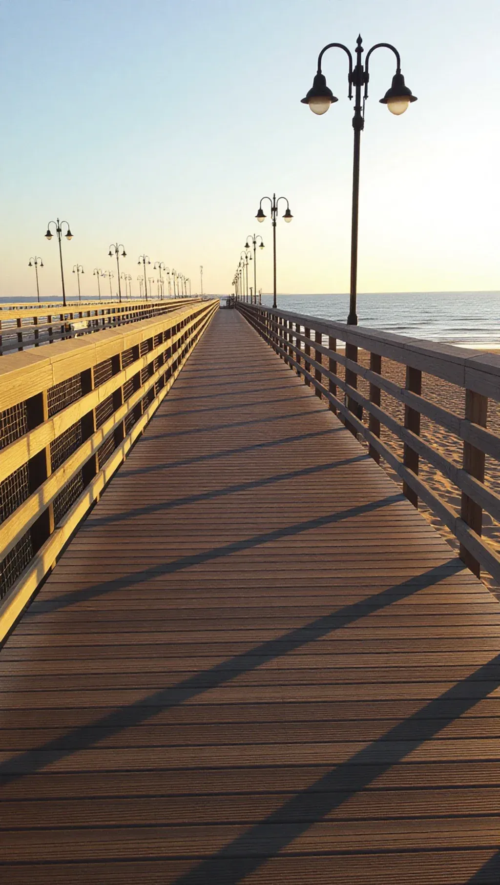 Adjustable steel footings supporting a pedestrian walkway